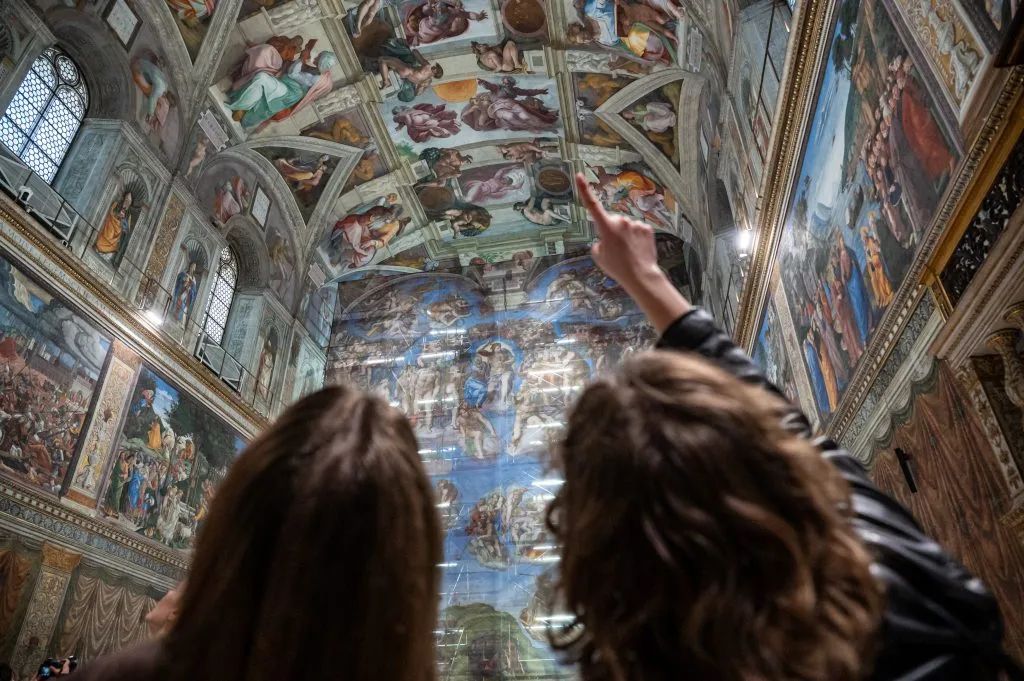 Image of Vatican visitors admiring the ceiling. Used for NLN article about the need to revive patrons of the arts.