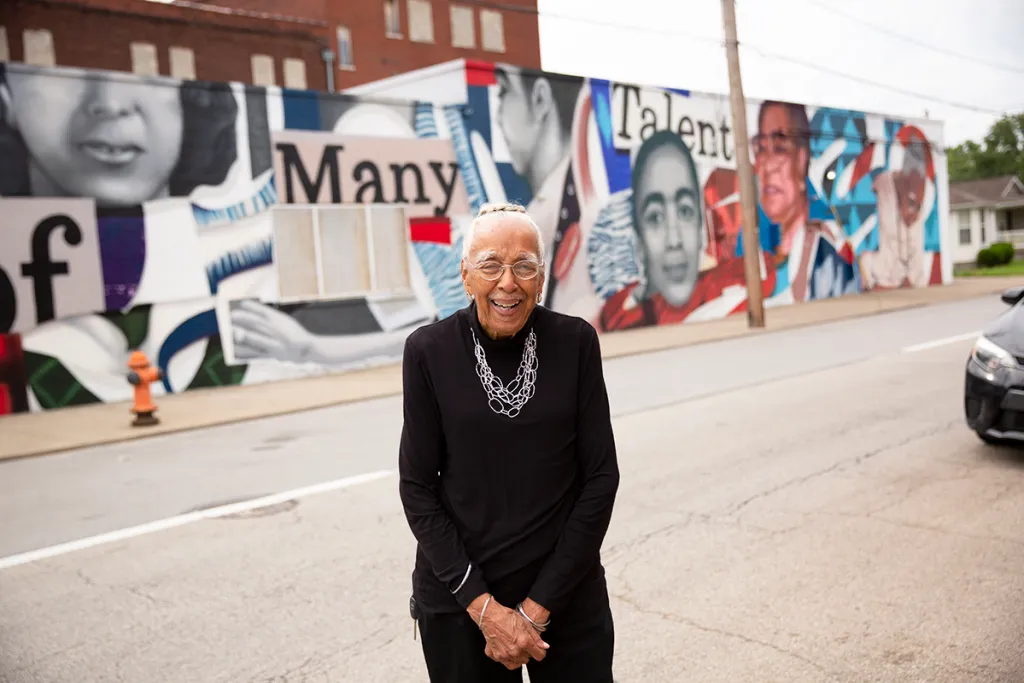 Elmer Lucille Allen stands in front of a mural in her hometown of Louisville, Kentucky that honors her and other legends of the West End.