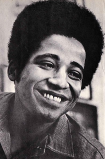 George Jackson, smiling through what must been a painful reality of being a Black revolutionary. He is one of the many reasons we celebrate Black August.